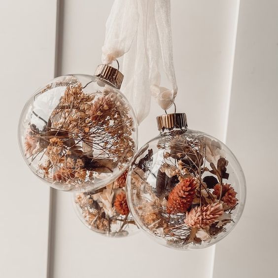 clear glass ornaments with dried blooms, leaves and grasses are amazing for boho Christmas decor