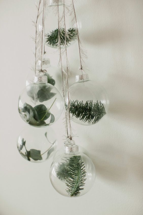 clear glass ornaments with greenery and evergreens are a gorgeous natural idea for Christmas, they will fit boho or woodland decor