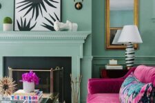 30 a light green living room with a fireplace and a cover, a magenta sofa with a bold pillow, a glass coffee table and chic artwork