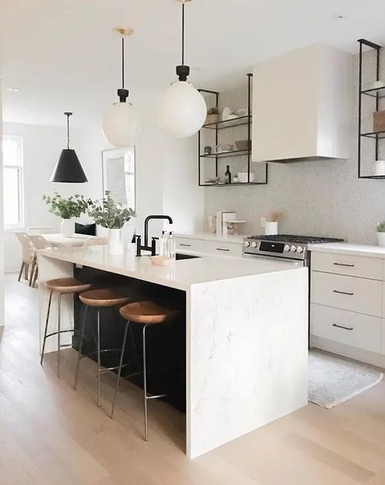 a chic contemporary kitchen with elegant white cabinets, a white tile backsplash, a black kitchen island with a white stone countertop and pendant lamps