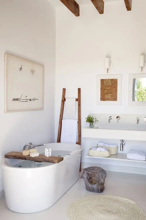 a modern spa-like bathroom with driftwood details and a large freestanding tub