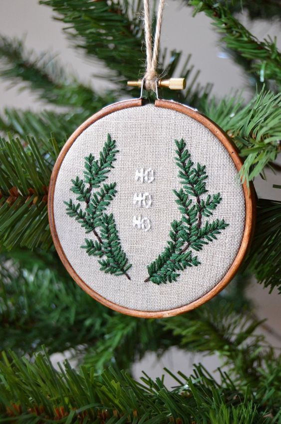 a rustic Christmas ornament of an embroidery hoop, embroidered branches and letters is a cool decoration