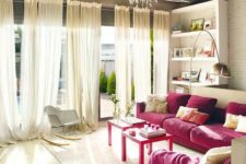 38 a refined neutral living room with built-in shelves, two magenta sofas, neutral furniture and textiles plus a crystal chandelier