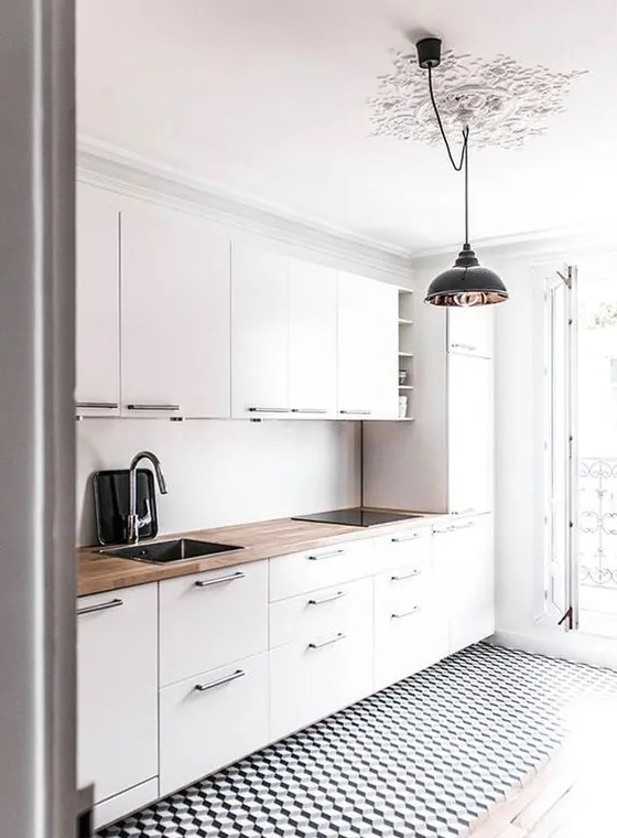 a modern white kitchen with a geometric floor and a wooden countertop to make it look more interesting