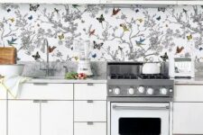 41 to avoid a boring look in an all-white kitchen, rock a colorful wallpaper backsplash with butterflies and birds