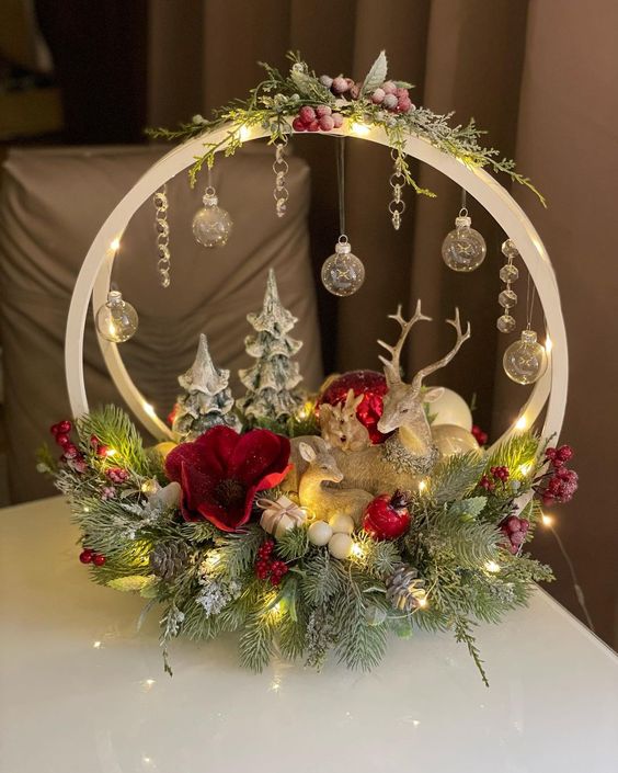 a bright Christmas decoration of embroidery hoops, evergreens, ornaments, beads, red blooms, trees and deer
