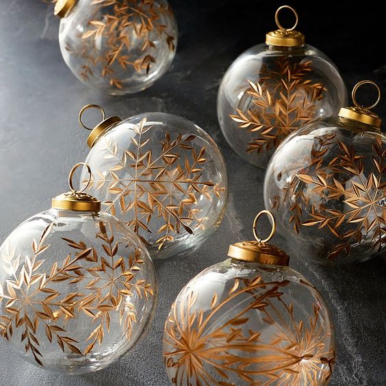 clear glass Christmas ornamens decorated with gold snowflakes look magical and will bring this magical touch to your tree