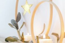45 Christmas decor with embroidery hoops, candles and stars hanging down is a lovely modern decor idea