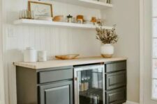 45 a mid-century modern with open shelves, black cabinetry, potted greenery and various decor and a wine cooler is a lovely idea for a farmhouse space