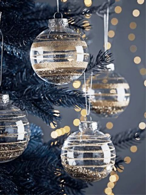 clear glass Christmas ornaments with gold glitter stripes and gold glitter inside are glam and chic