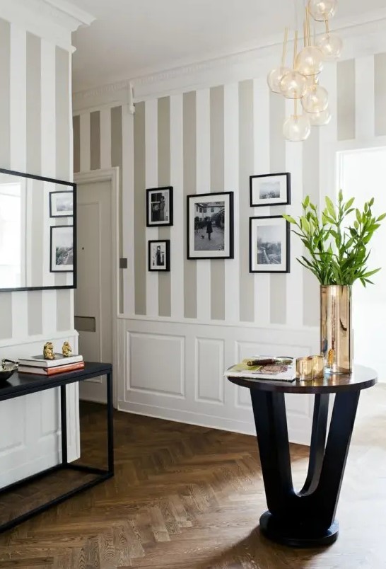 traditional grey and white vertical stripes like these ones are great for making your ceilings look higher, and white paneling adds elegance here