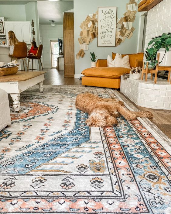 a gorgeous muted color printed boho rug adds coziness and a welcoming feel to the living room