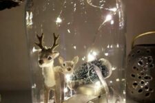 a Christmas terrarium with faux snow, a mini car with a tree and a couple of cute deer figurines is amazing