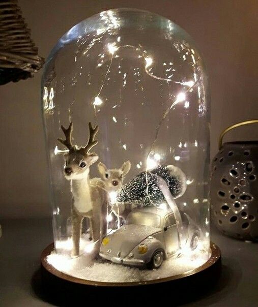 a Christmas terrarium with faux snow, a mini car with a tree and a couple of cute deer figurines is amazing