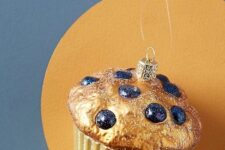 a beautiful and delicious-looking gilded blueberry muffin ornament is a perfect decoration for a Christmas tree