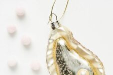 a beautiful oyster with a pearl Christmas ornament is a very refined and delicate decoration for your Christmas tree