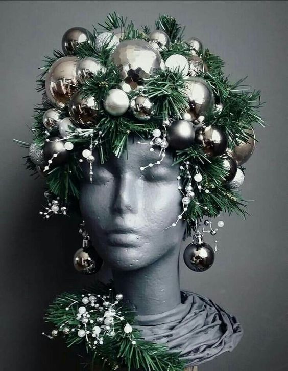 a bust decorated with evergreens, snowy pieces and silver ornaments as a headpiece and earrings is a unique idea for Christmas