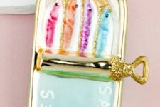 a can with colorful sardines and touches of gold glitter is a super fun decor idea for Christmas