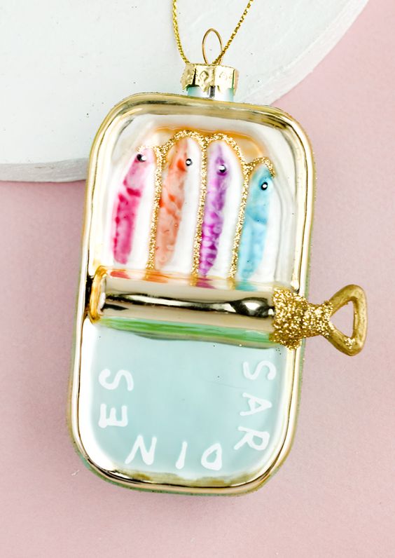 a can with colorful sardines and touches of gold glitter is a super fun decor idea for Christmas