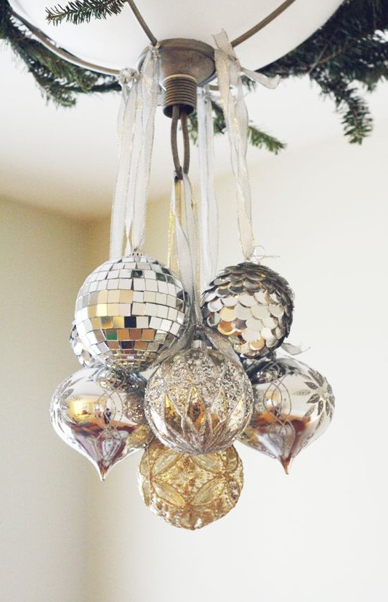 a chandelier spruced up with silver, silver sequin and silver glitter ornaments for Christmas is chic