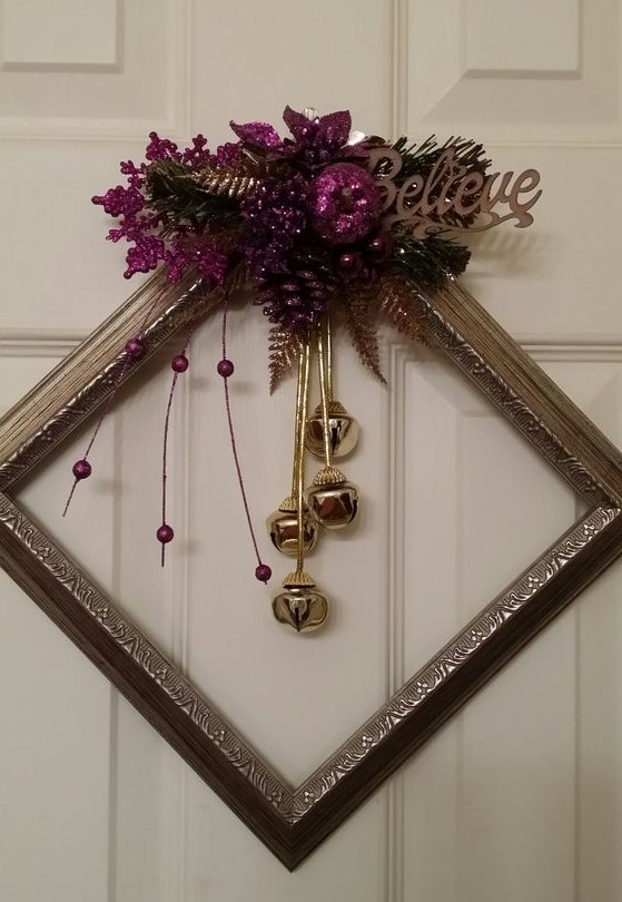 a chic metallic frame Christmas wreath with gold bells, purple glitter decor and leaves plus a word