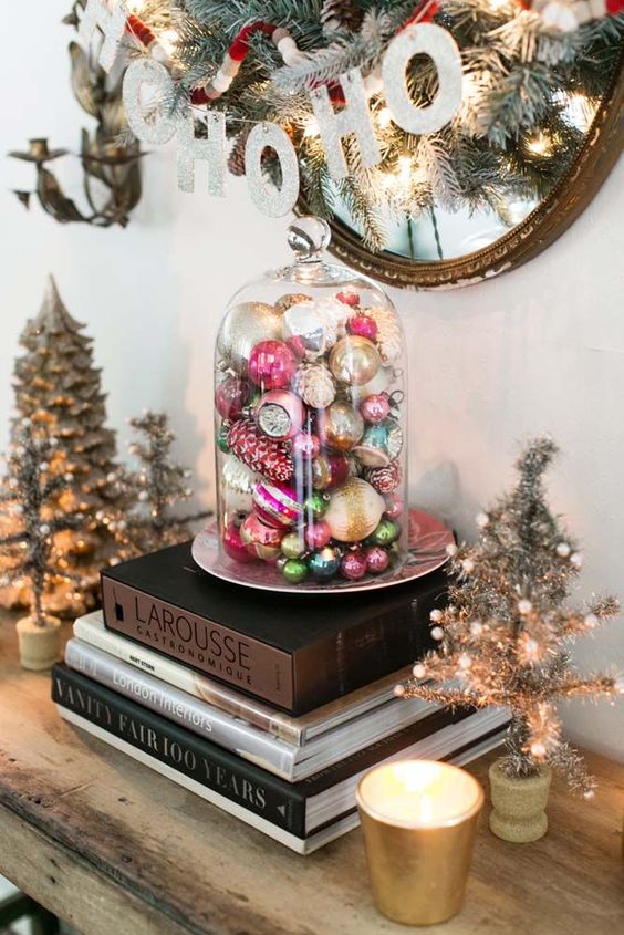 a cloche with vintage Christmas ornaments is a lovely decoration or display for the holidays