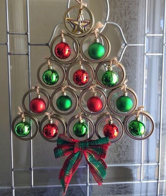 a creative Christmas tree of jar lids, green and red Christmas ornaments and a plaid bow