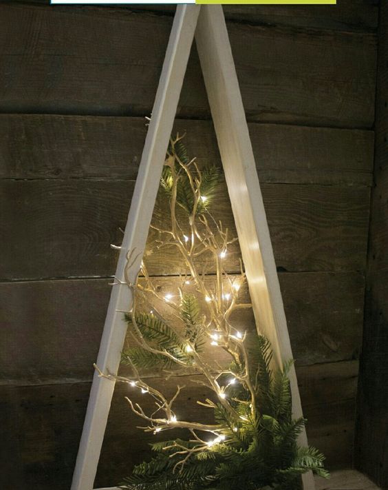 a creative frame Christmas tree with lit up branches and evergreens will be a modern and fresh take on a traditional tree