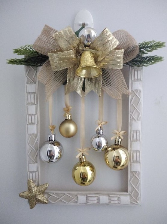 a frame Christmas wreath with a gold star, evergreens, silver and gold ornaments, burlap and a ribbon bow plus a bell