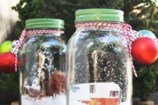 a jars with faux snow, a vintage van, some faux birds and Christmas ornaments are very pretty holiday terrariums