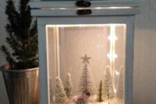 a lantern Christmas terrarium with faux snow, a vintage van carrying a tree, some snowy bottle brush trees and lights