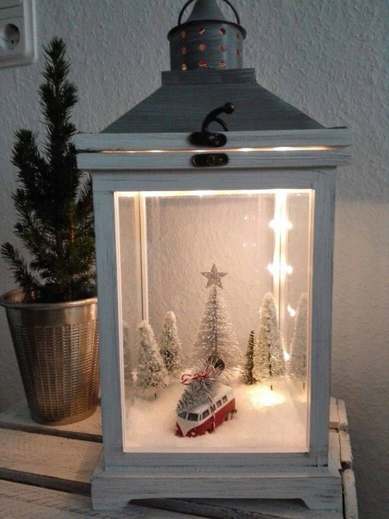 a lantern Christmas terrarium with faux snow, a vintage van carrying a tree, some snowy bottle brush trees and lights