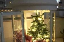 a lovely lantern with a small Christmas tree