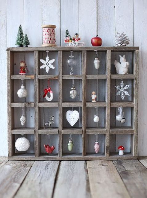 a pretty rustic Christmas ornament stand of wood, with various Scandi-themed ornaments and some additional decor on top