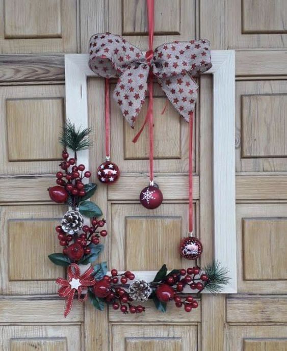 a red and white frame Christmas wreath with a printed bow, berries, pinecones and red bows, three red and white ornaments