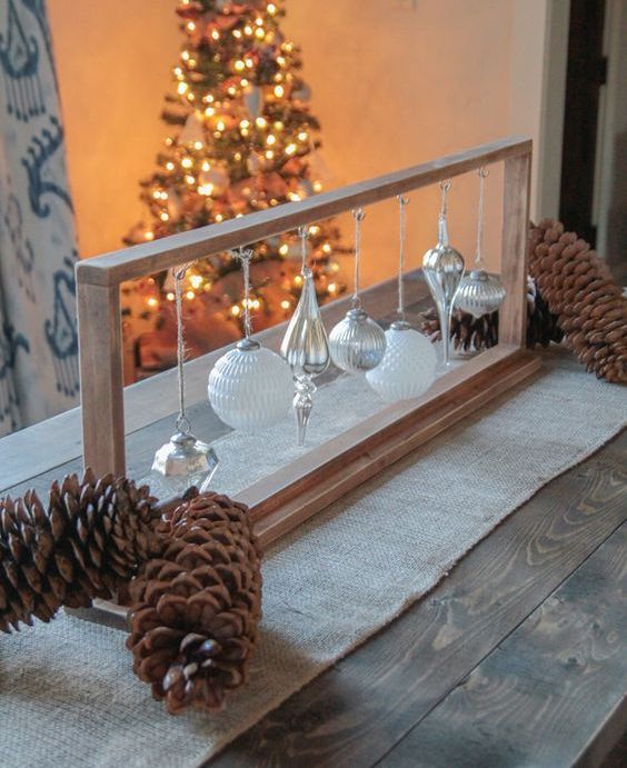 a simple wooden frame with a whole assortment of white and silver Christmas ornaments will be a nice DIY Christmas decoration