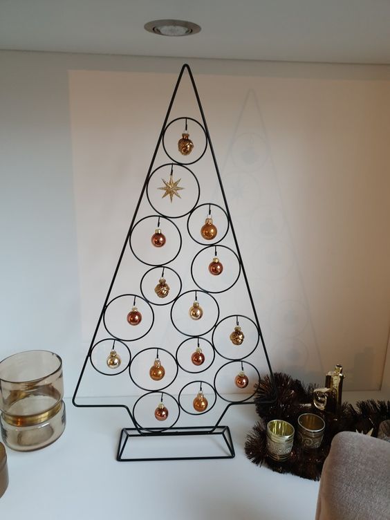 a tabletop metal frame Christmas tree with tiny copper and gold ornaments hanging is amazing for the holidays