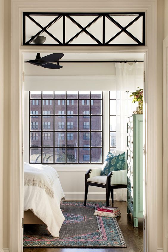 a transom window with criss cross frames adds to the aesthetic value of the interior and there's a shelf to display something there