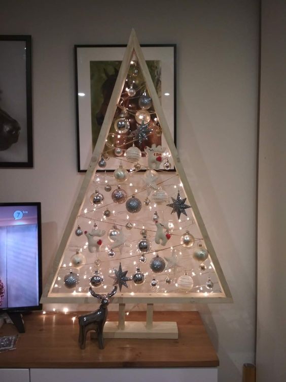 a whitewashed Christmas tree with lights, white and silver ornaments is a stylish tabletop decoration for the holidays
