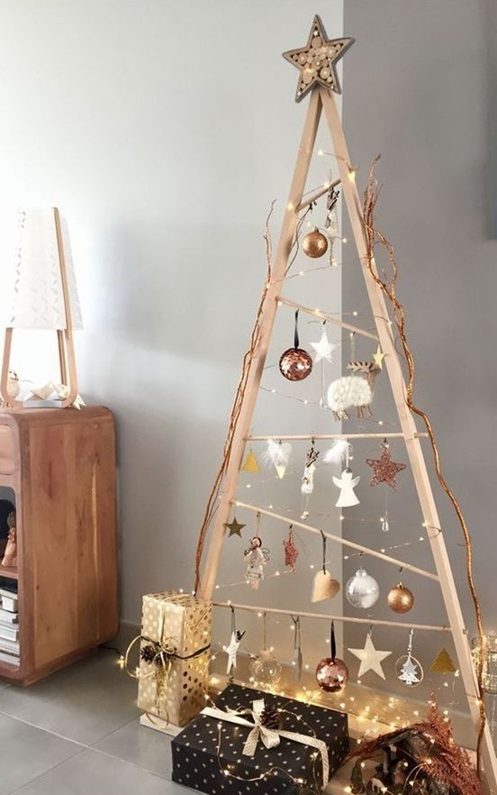 a wooden frame Christmas tree with lights, white, copper, silver and clear ornaments hanging on it and a star topper is a fresh idea to try