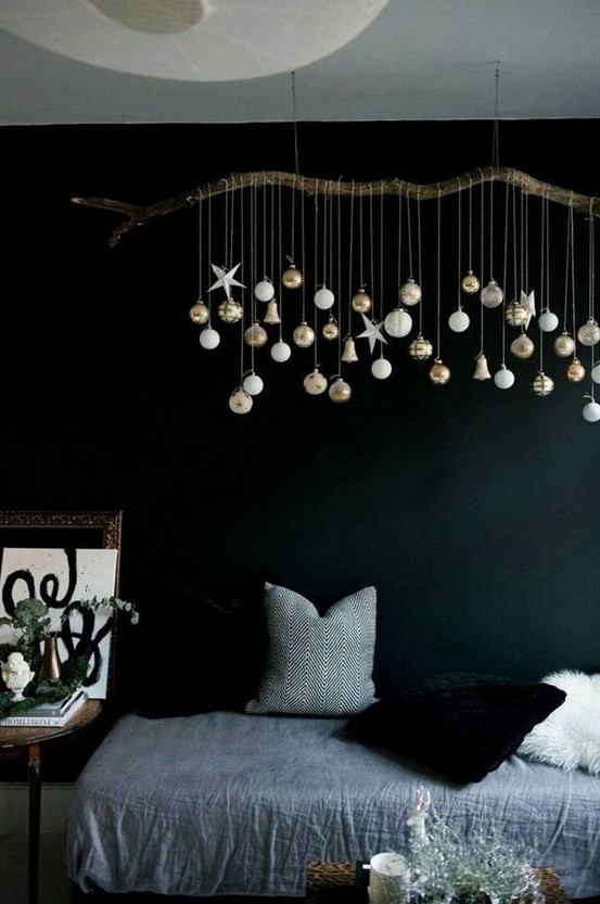 an overhead Christmas installation of a branch with white and gold ornaments is a great idea for every kind of space