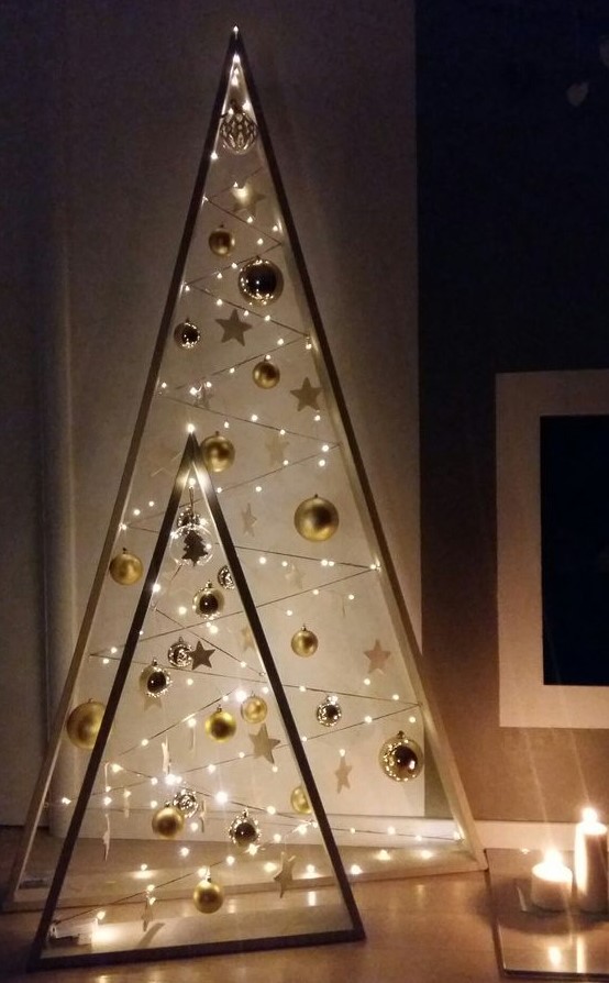 beautiful frame Christmas trees with gold ornaments, stars and lights are amazing to give a touch of shine and an eye-catchy look to your space