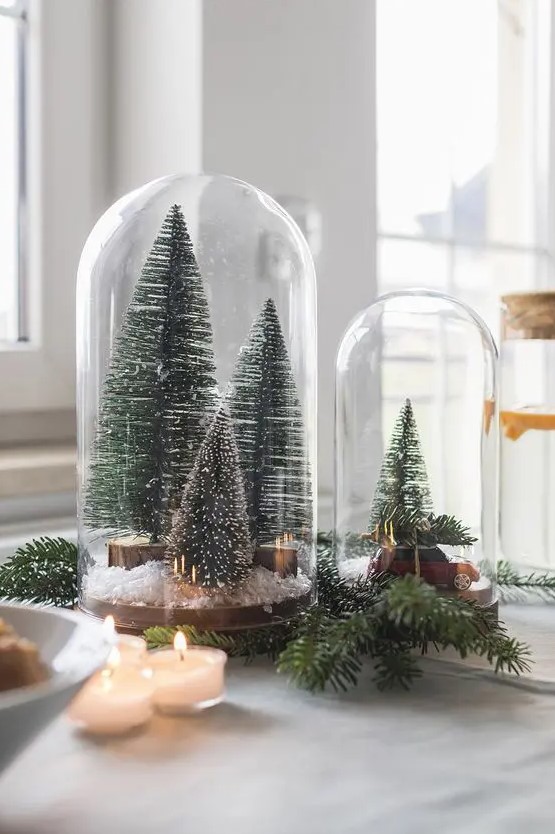 cloches with bottle brush Christmas trees, faux snow and a small car are amazing for holiday styling