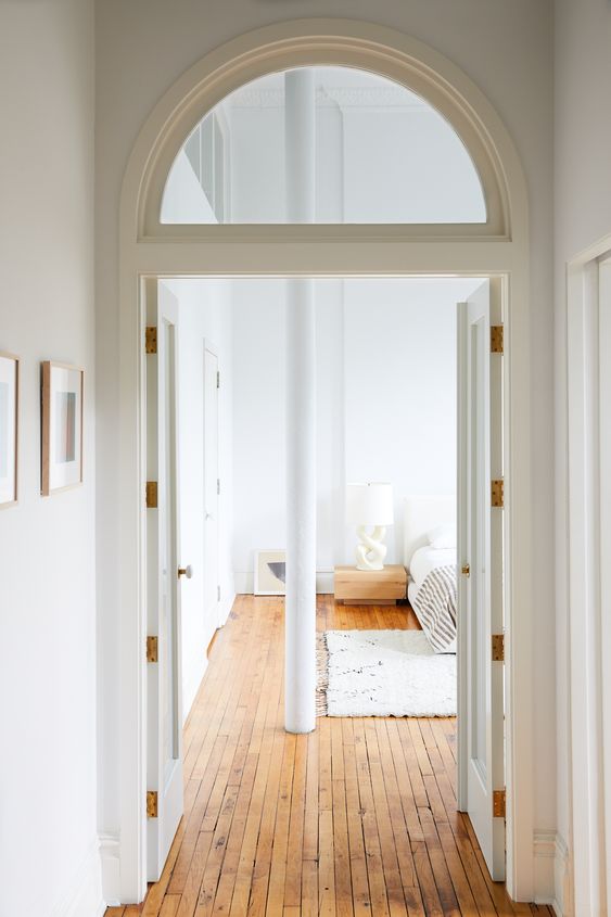 doors paired with an arched transom window look very stylish and chic and add to the decor of the space