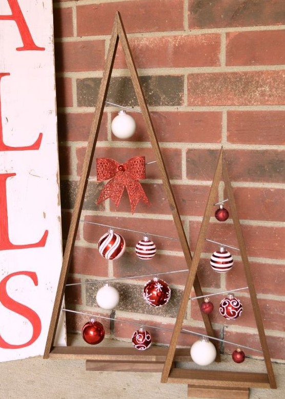 stained frames with red and white Christmas ornaments and bows are amazing to add a touch of color to the space