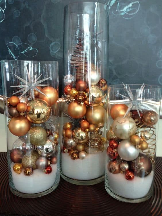 tall glasses with faux snow and bold metallic and clear Christmas ornaments are a lovely arrangement to display your ornaments