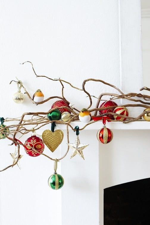 vine-like branches on the mantel with a whole assortment of beautiful Christmas ornaments will add a festive feel to the space