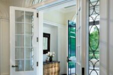 vintage doors with sidelights and an arched transom window highlight the history of the house giving it a chic and elegant look