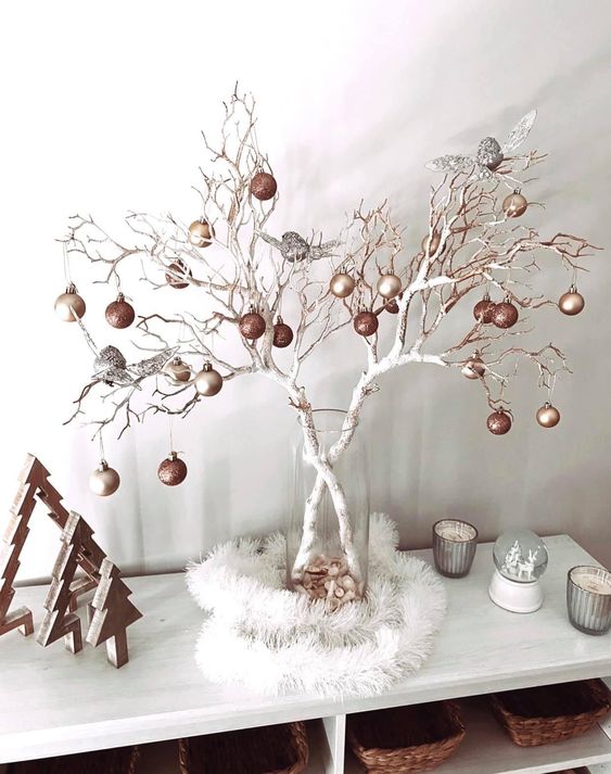white branches decorated with copper, matte gold and silver ornaments are a nice Christmas ornament display and decoration