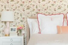 06 a cozy vintage-inspired bedroom with a floral wallpaper wall, polka dot bedding, vintage-inspired furniture and a blush lamp